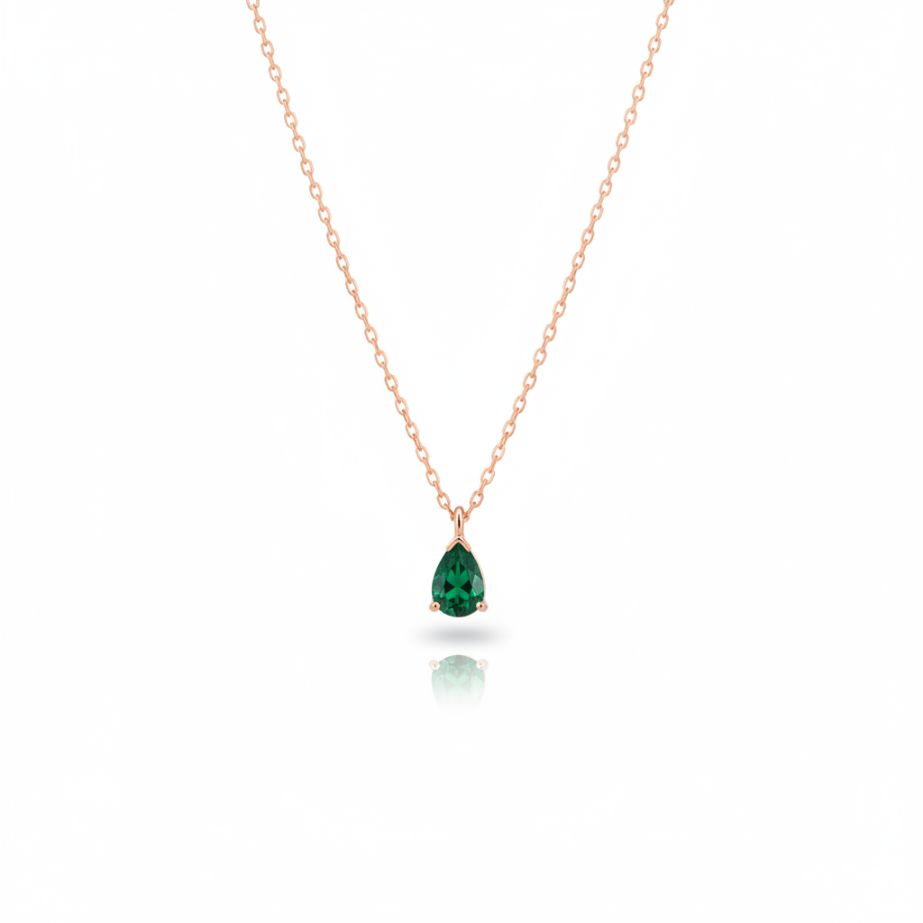 Delicate gold necklace with green teardrop gemstone