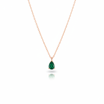 Delicate gold necklace with green teardrop gemstone