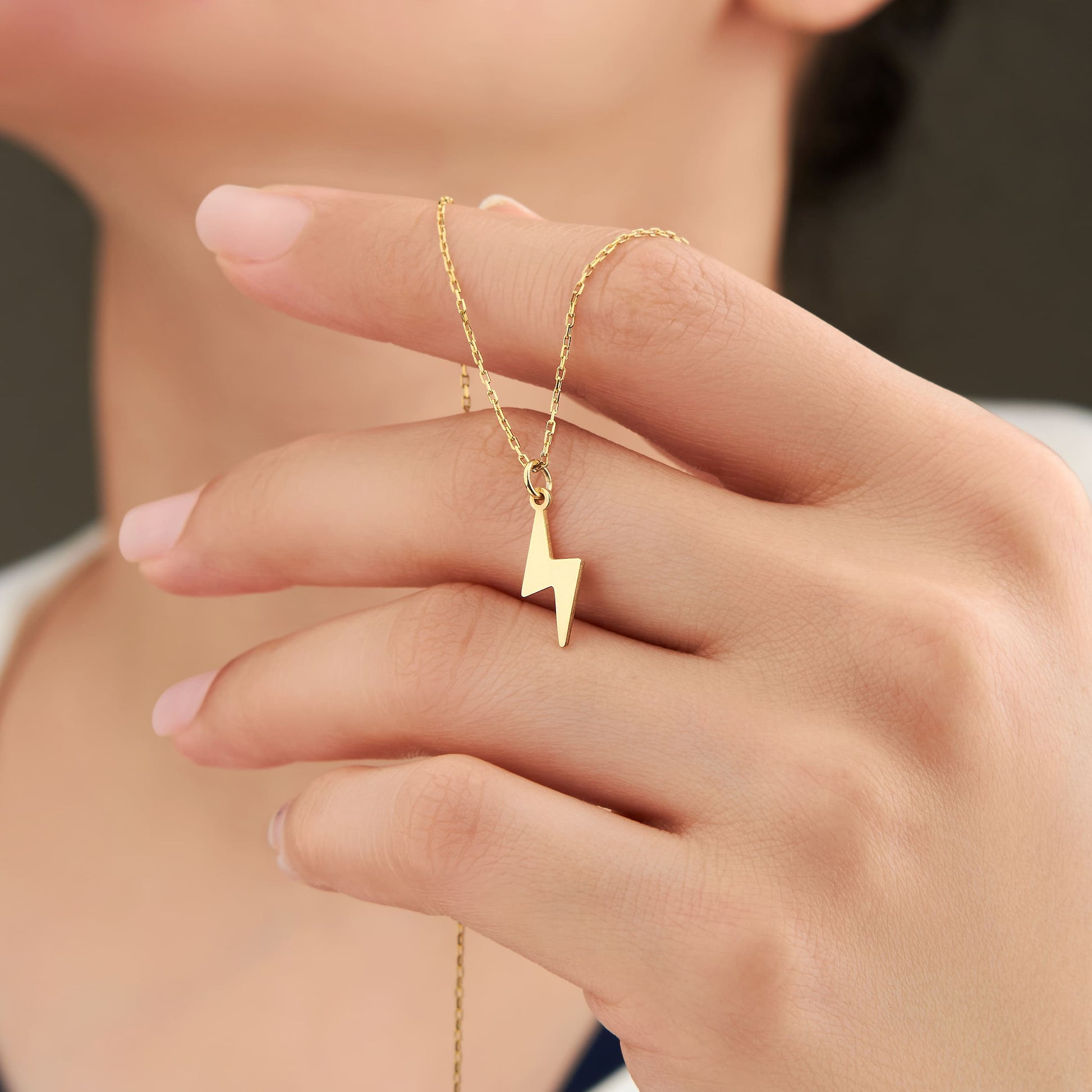 tiny thunderbolt pendant in solid gold