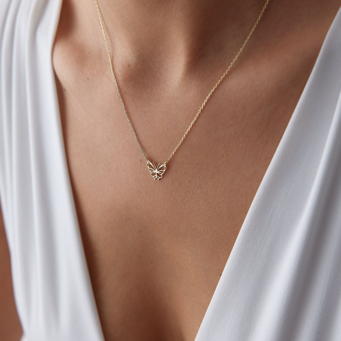 minimalist gold butterfly charm
