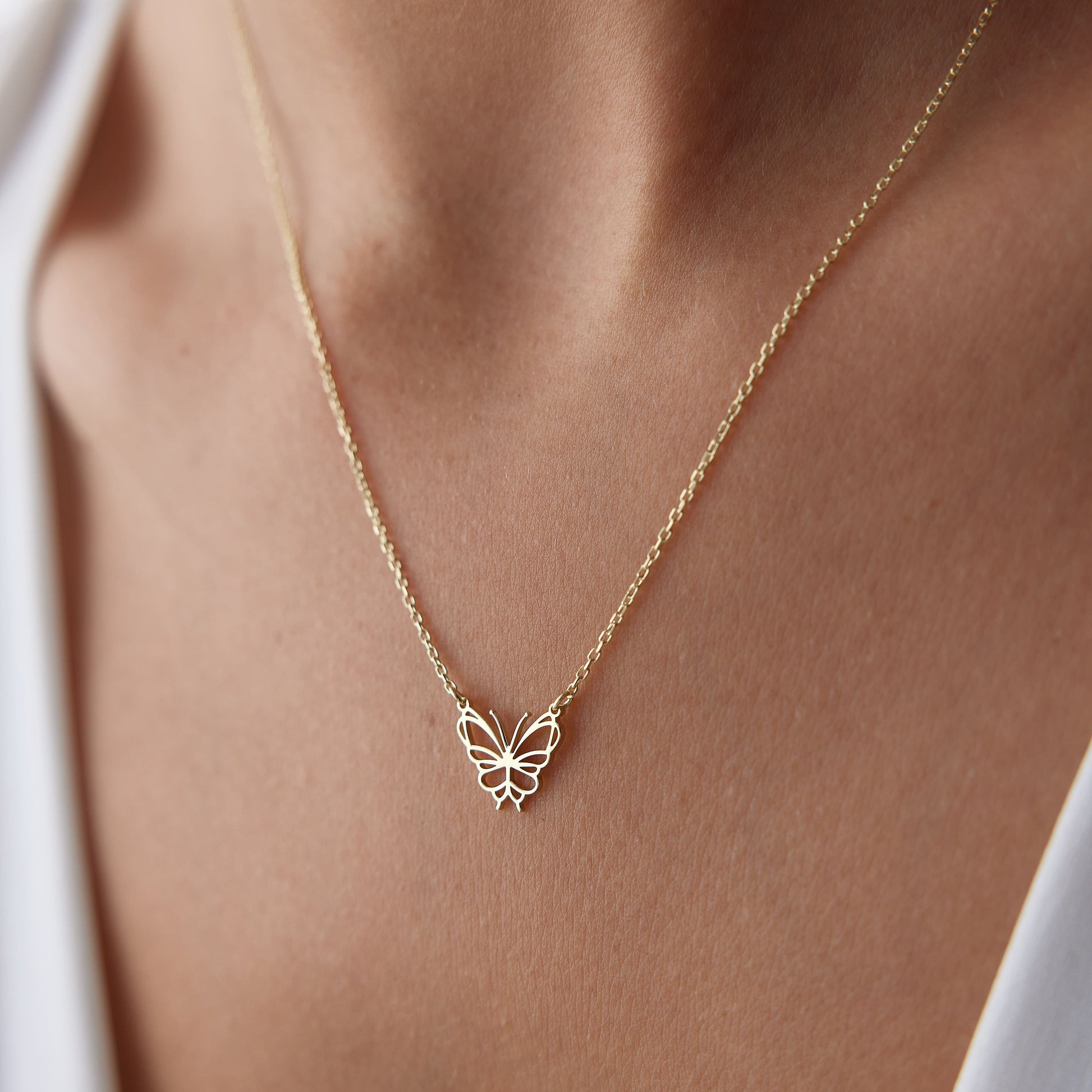 minimalist gold butterfly charm